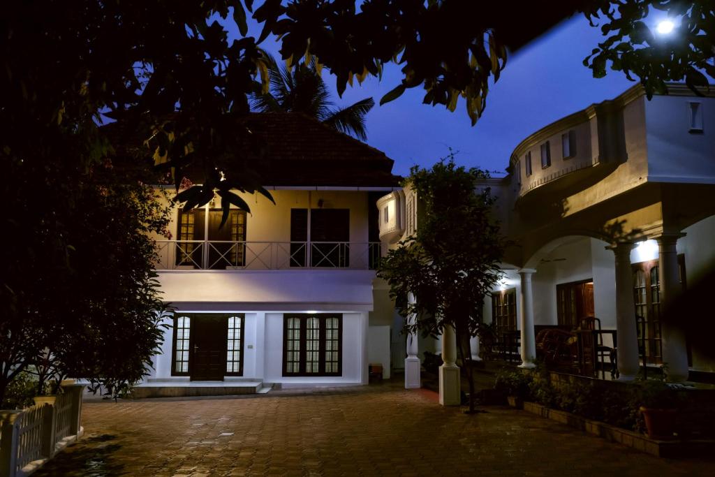 a large white house at night at Vaiga Homes - Vembanadu Lakeview Retreat in Cochin