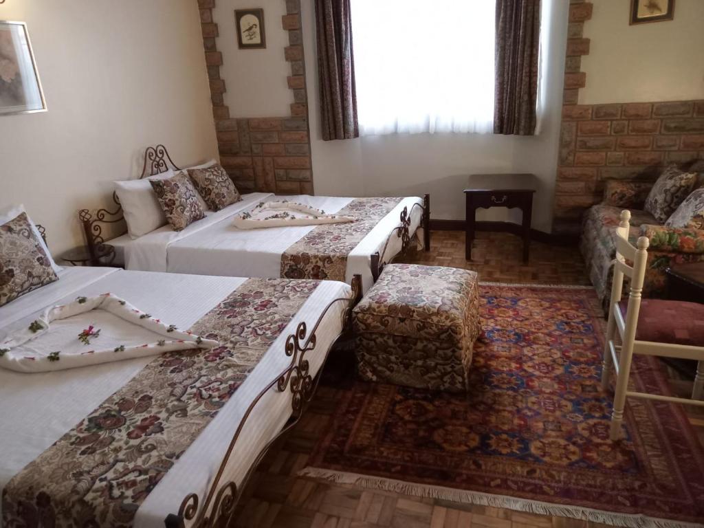 Postel nebo postele na pokoji v ubytování The Drexel House Kenya