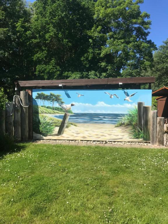 a mural of a beach with birds on it at Ferienwohnung Möwe in Graal-Müritz