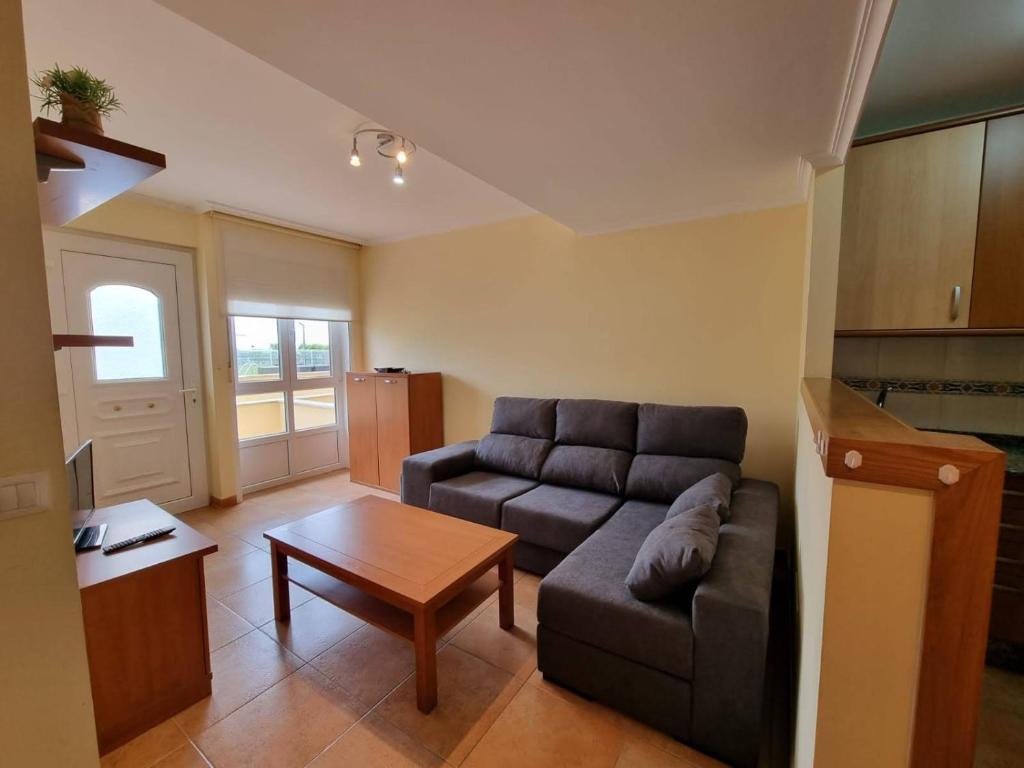 a living room with a couch and a table at Apartamento en Playa Rapadoira in Foz