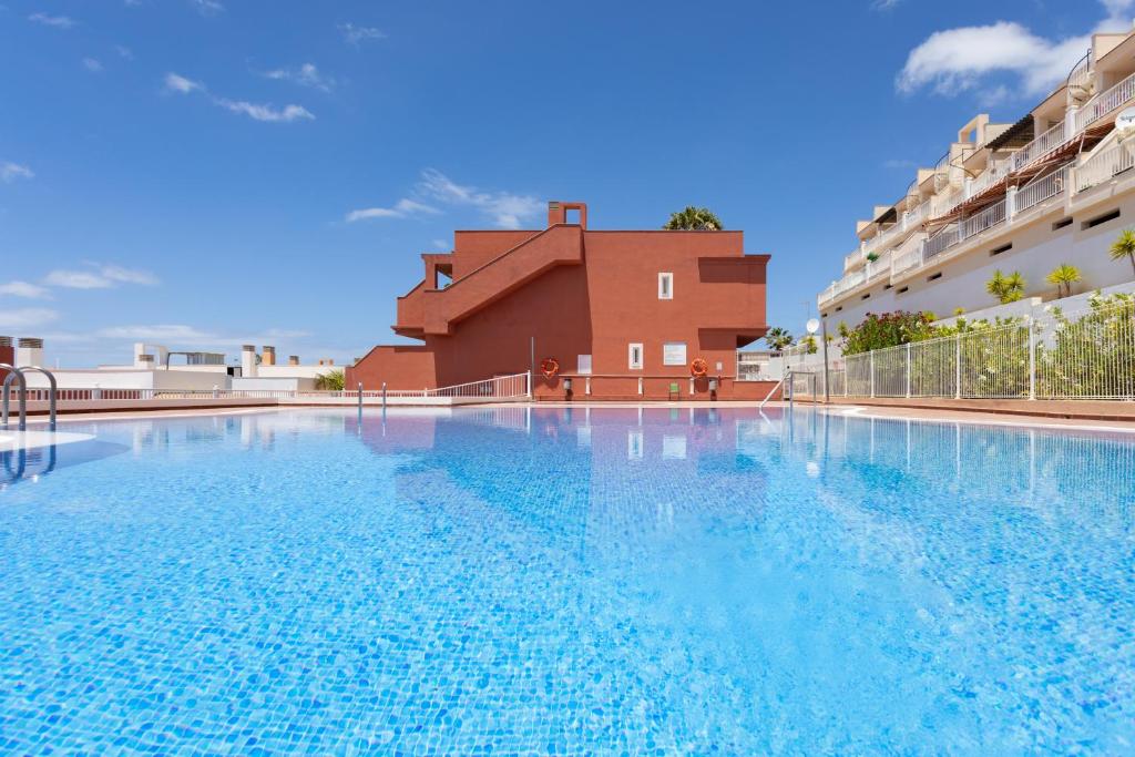 a large swimming pool in front of a building at Home2Book Calma Sun Home Chayofa, Terrace & Pool in Chayofa