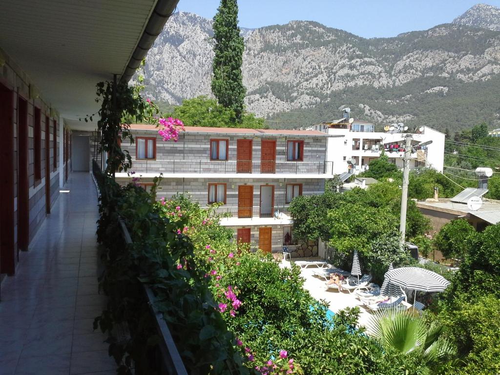a balcony with a view of a building with flowers at İPSOS HOTEL BELDİBİ in Kemer