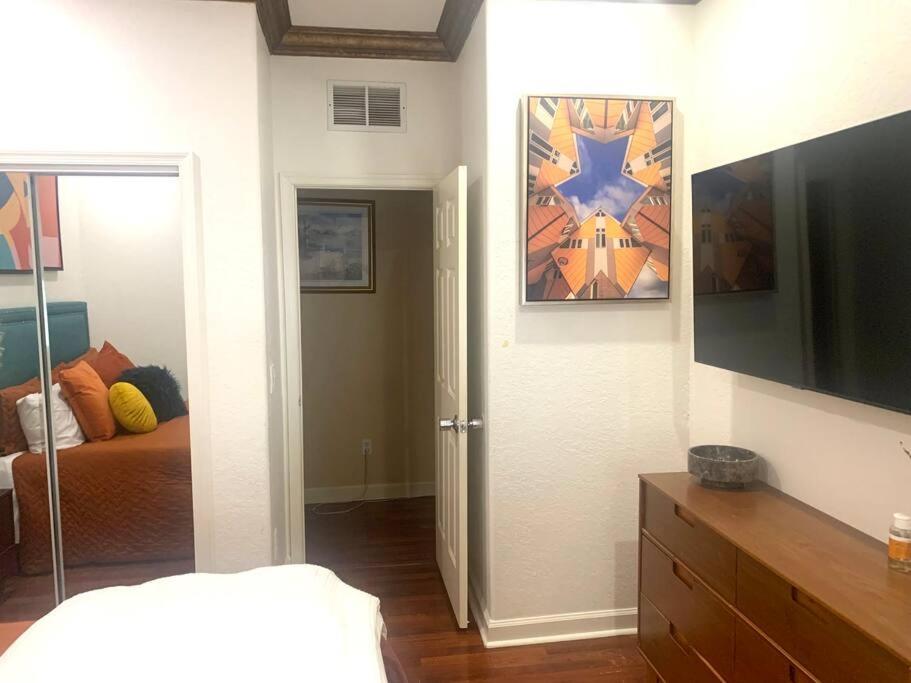 a bedroom with a bed and a flat screen tv at Relaxation Zone in West Palm Beach