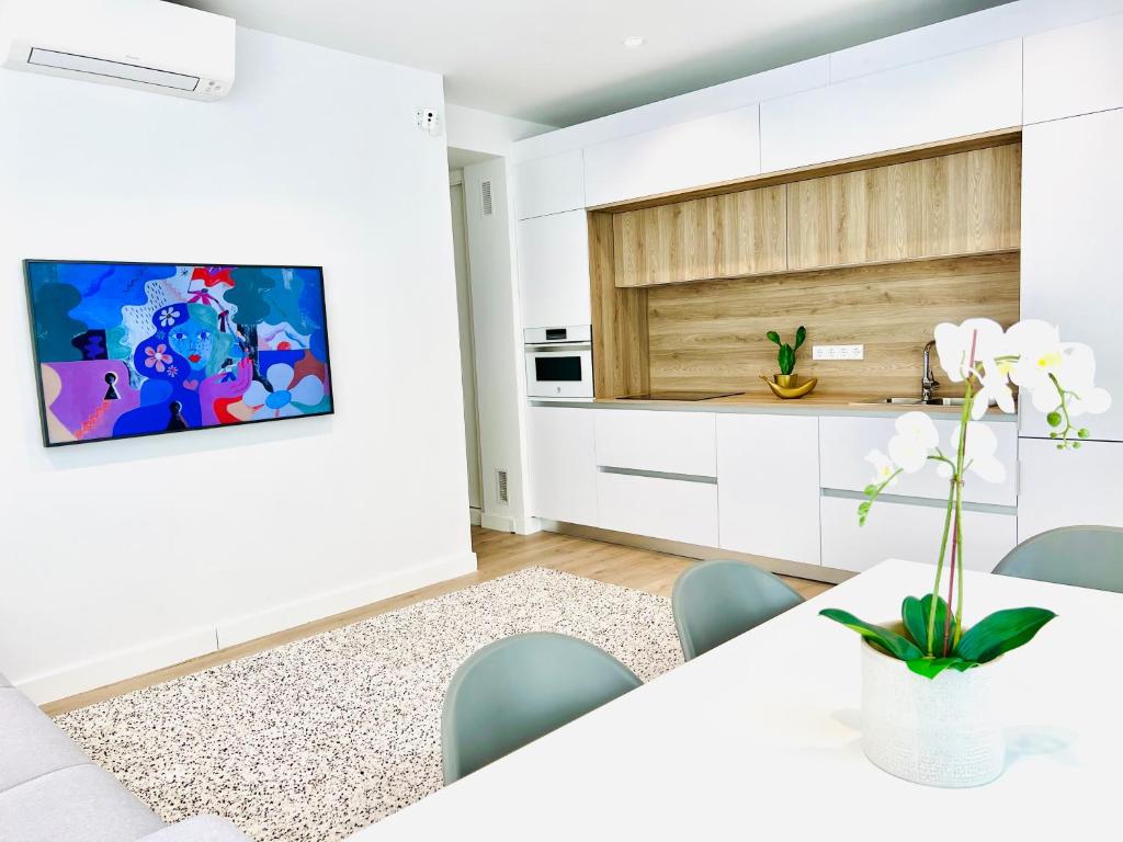 a white kitchen with a table and chairs at BEST LOFT NEAR REAL MADRID STADIUM in Madrid