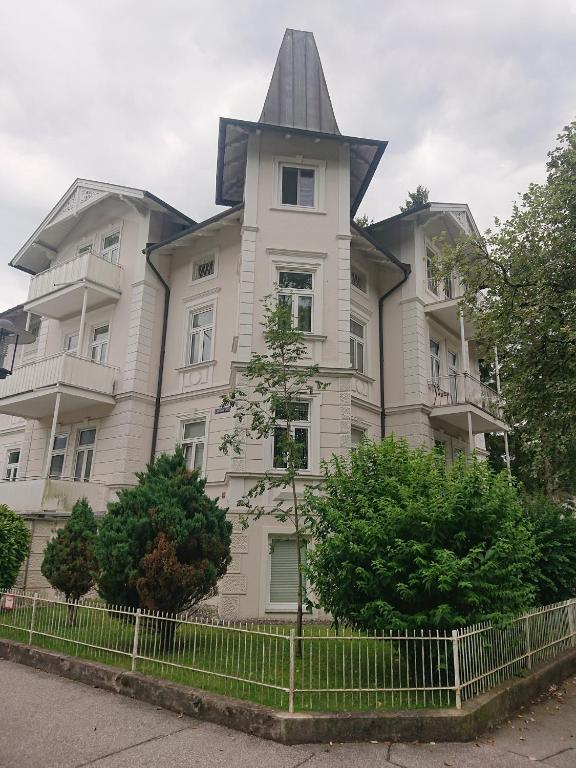 a large white house with a pointed roof at Ferienwohnung Barbarossa in Bad Reichenhall