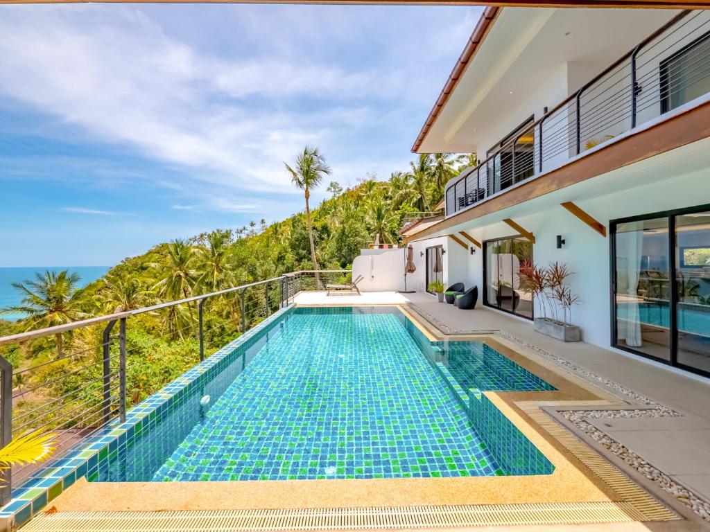a villa with a swimming pool and the ocean at Villa AUREA Sea View in Koh Samui