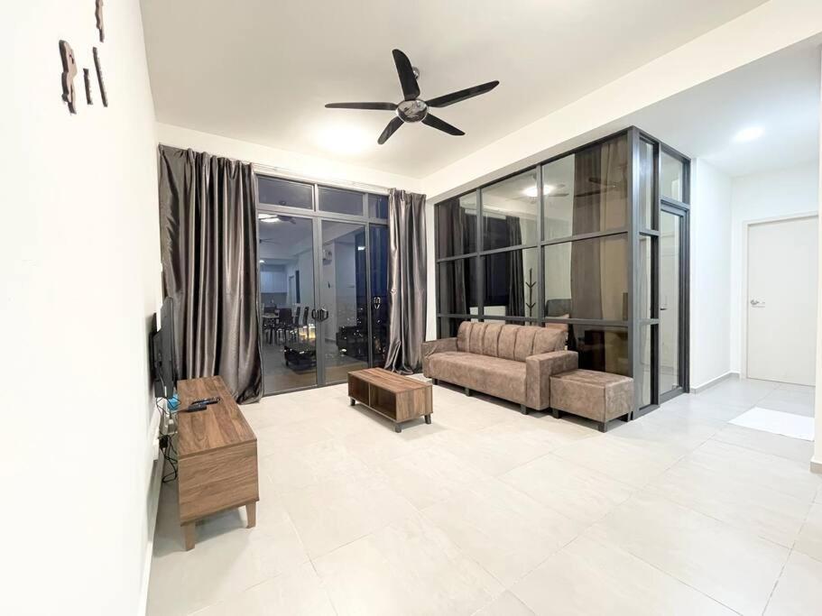 a living room with a couch and a ceiling fan at Quartz near to Jonker Walk with Infinity Pool Cozy 3B2B in Malacca
