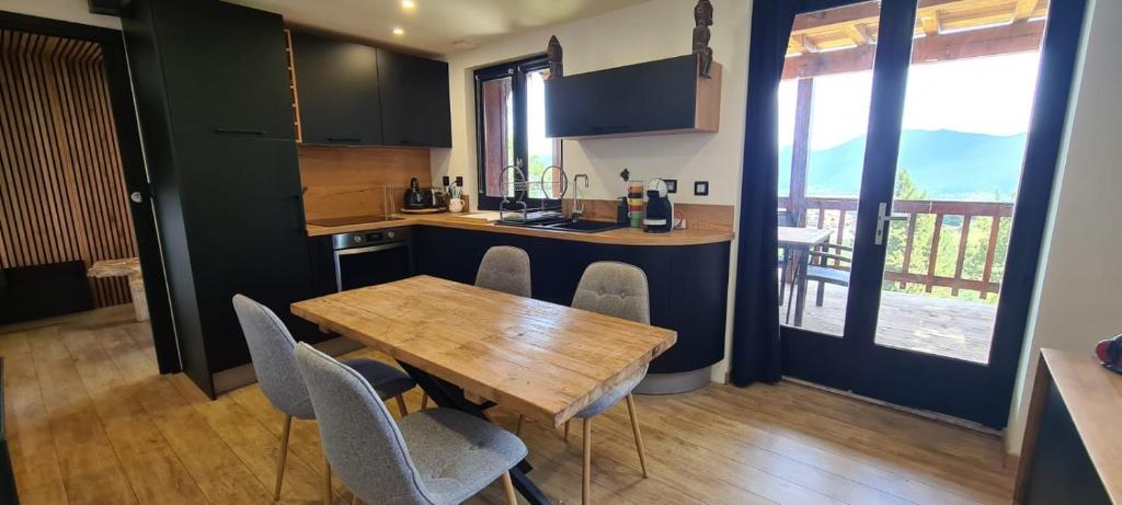 a kitchen with a wooden table and chairs at Chez Rémy in Les Angles