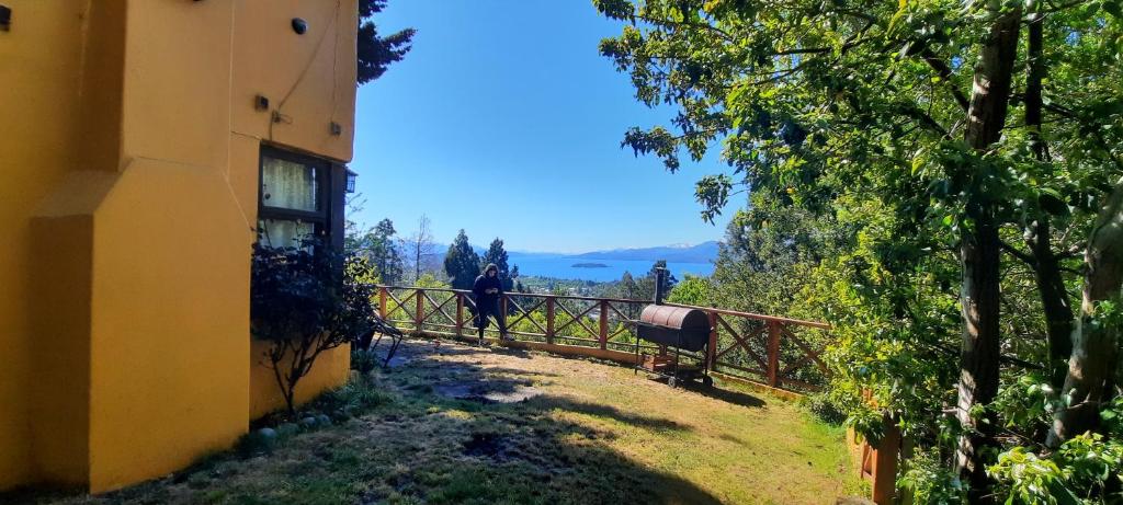 a person walking down a path next to a building at La mas bella vista in San Carlos de Bariloche
