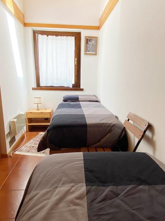 A bed or beds in a room at Appartamento con Terrazzo Panoramico vicino al Centro di Folgaria
