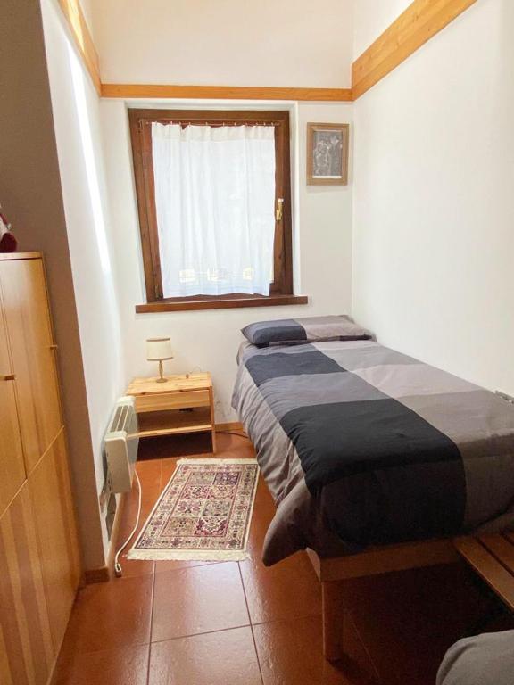 A bed or beds in a room at Appartamento con Terrazzo Panoramico vicino al Centro di Folgaria