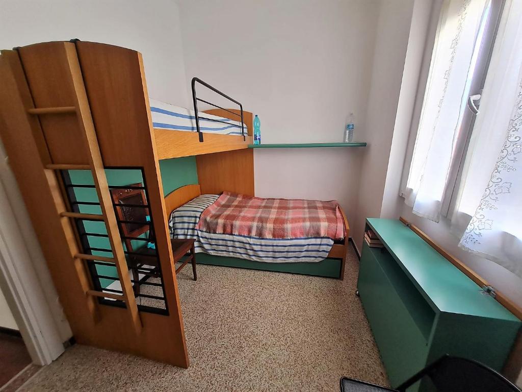 a small room with a bunk bed and a bunk ladder at Appartamento Il Cigno in Rapallo