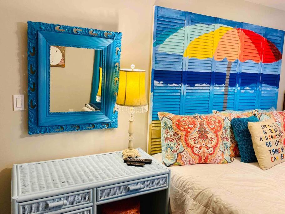 a bedroom with a mirror and a bed with a mirror at Mini Pearl, Private 2 BR - 1 block to BEACH! in Tybee Island