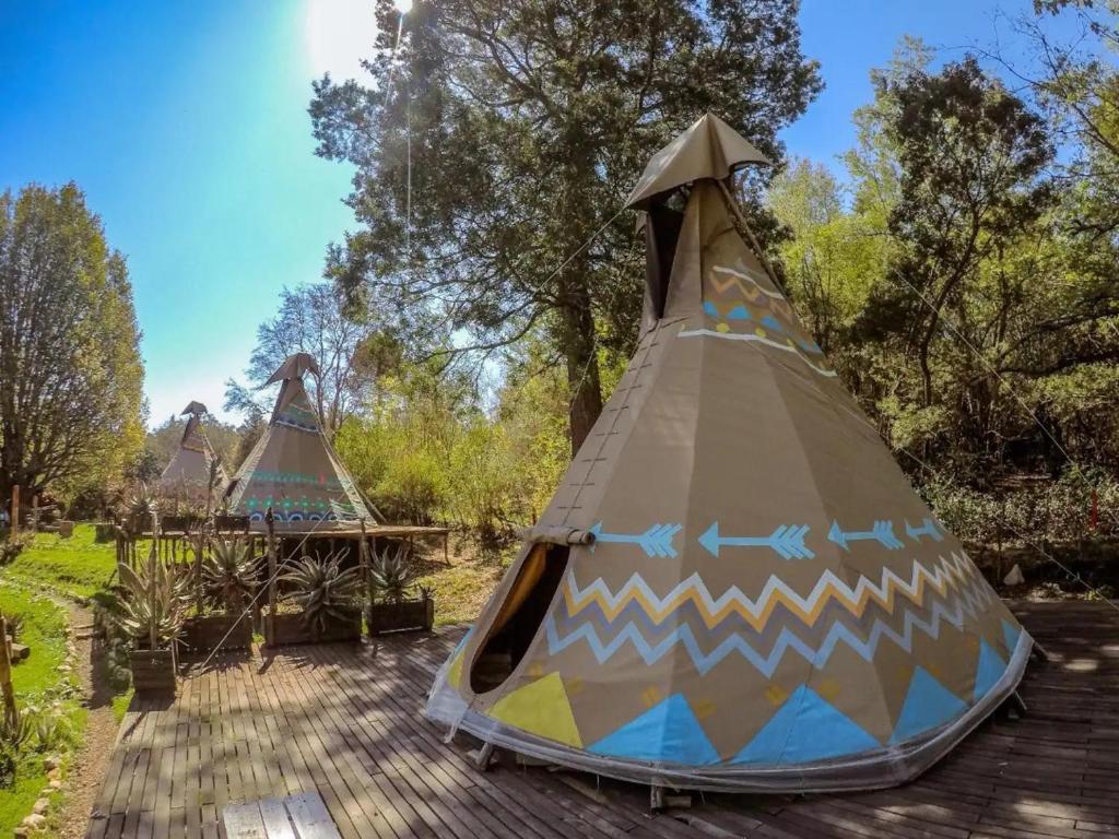 a couple of tents sitting on top of a deck at The Magical Teepee Experience in Hogsback