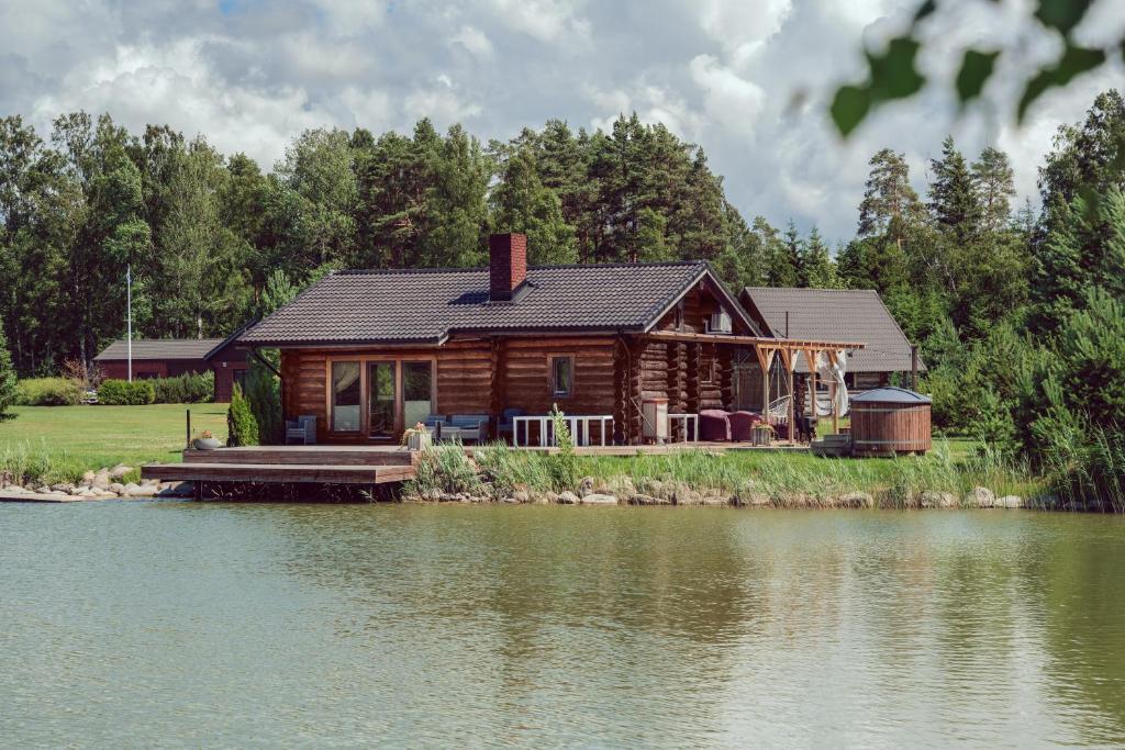 a log cabin on the shore of a lake at Marguse Metsamajad in Pärnu