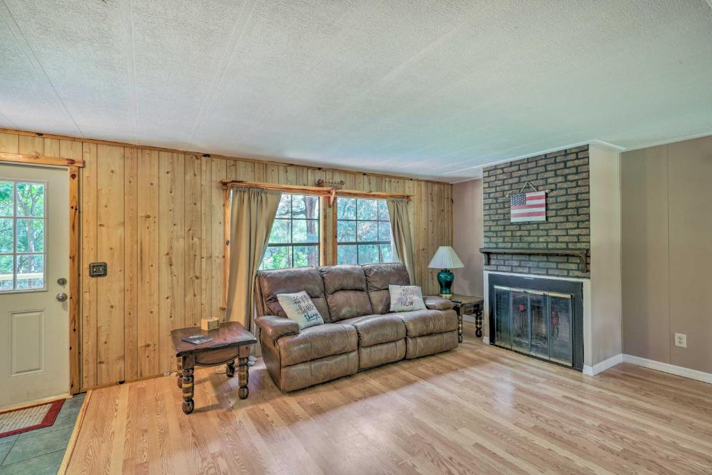 a living room with a couch and a fireplace at Suwannee Riverfront Home Grill, Near Springs in Branford