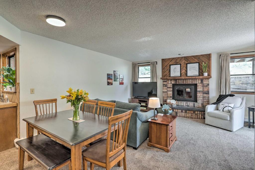 a living room with a table and a couch at Grand Junction Townhome about 3 Mi to Downtown! in Grand Junction