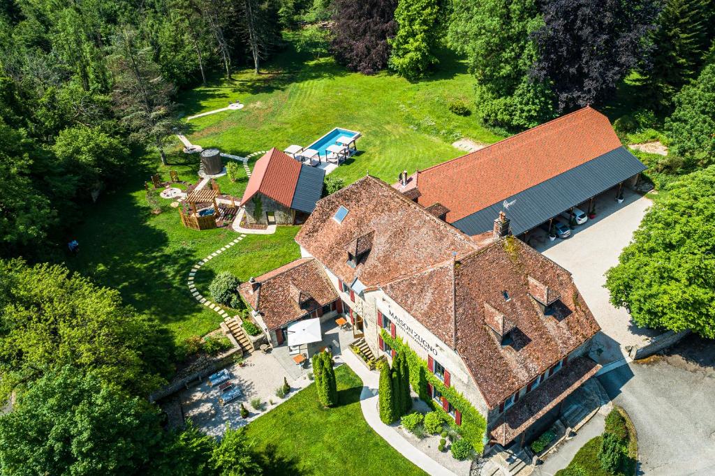 an aerial view of a large house with a yard at Maison Zugno Hôtel & Spa in Barretaine