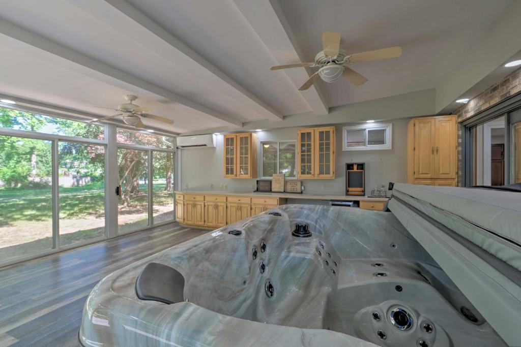 a large kitchen with a bed and a ceiling fan at Coastal Edgewater Home with Private Hot Tub! in Annapolis