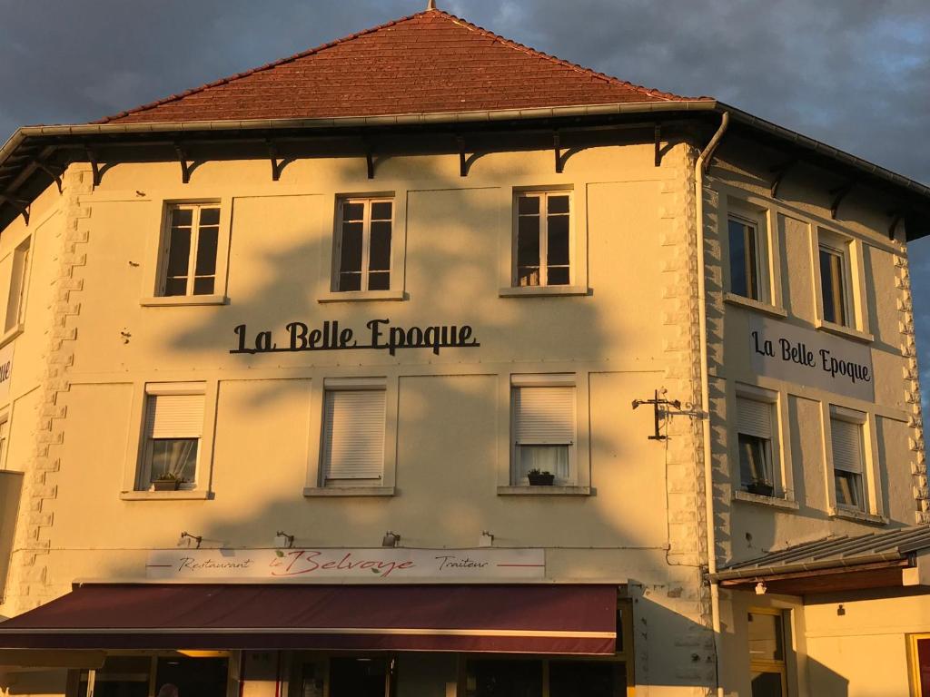 a building with a sign on the side of it at La belle Epoque in Damparis