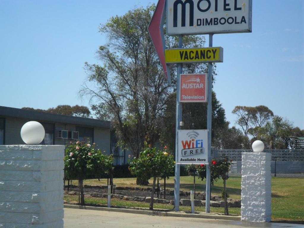 a pole with street signs in front of a building at Motel Dimboola in Dimboola