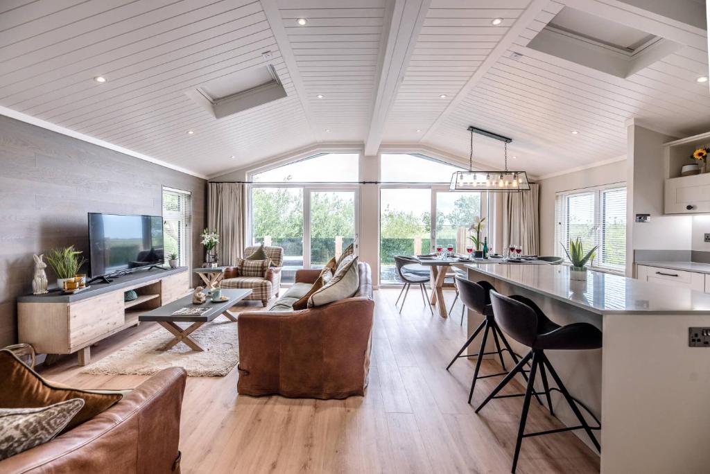 a kitchen and living room with a couch and a table at Briargate, Aldeburgh in Aldeburgh