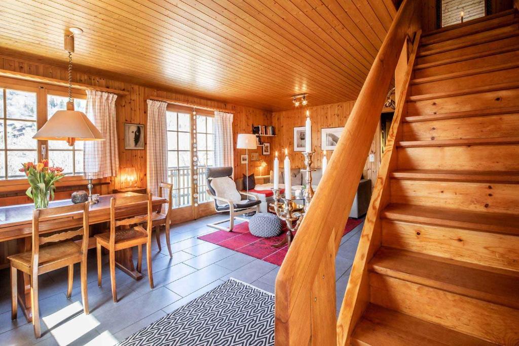 a living room with a wooden staircase in a house at Chalet Annabelle in Fiesch