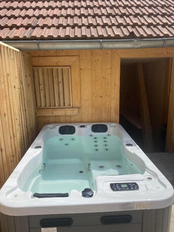 a bath tub sitting in the middle of a house at Ferme De La Prairie D Hergauchamps mit Sauna und Whirlpool in Sainte-Marie-aux-Mines