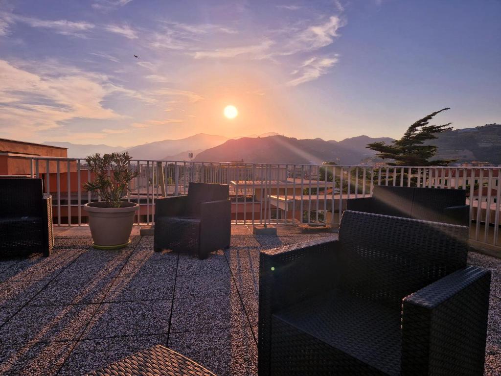 a view of the sun setting on a balcony at Residence Laura in Bordighera