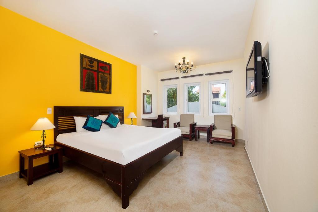 Postel nebo postele na pokoji v ubytování Gold Coast Da Nang Hotel