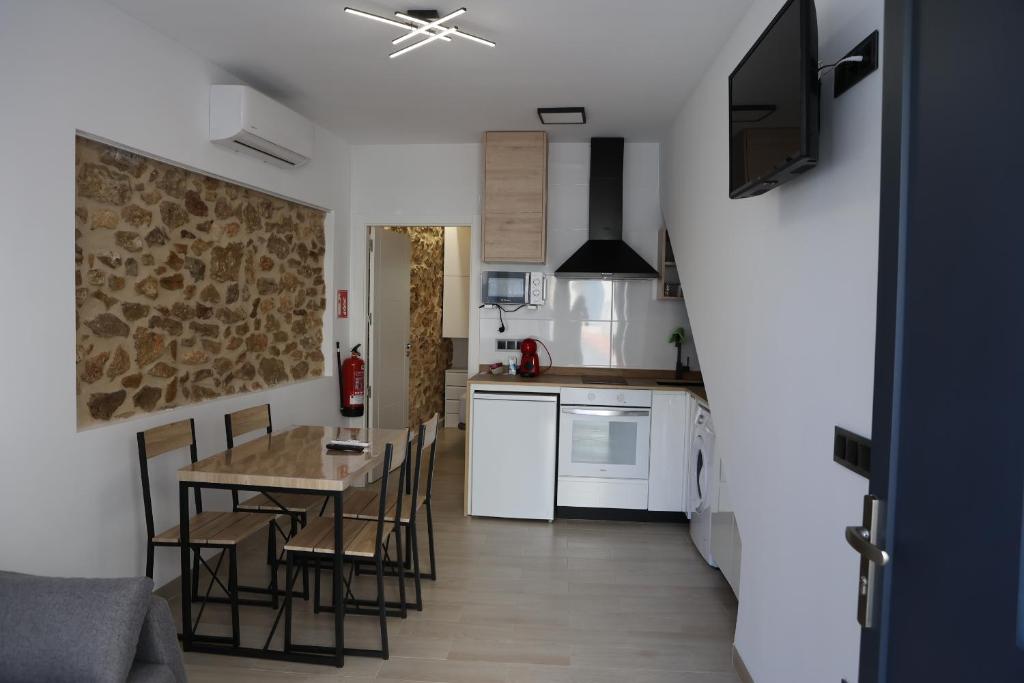 a kitchen and dining room with a table and chairs at Ca ma mare in Useras
