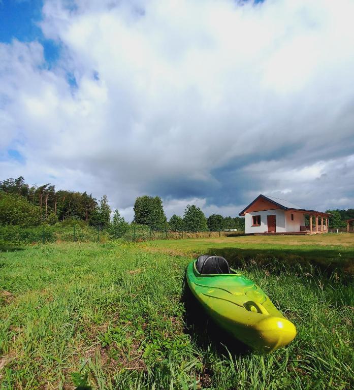 a kayak sitting on the grass in a field at Choczewski Zakątek in Choczewo