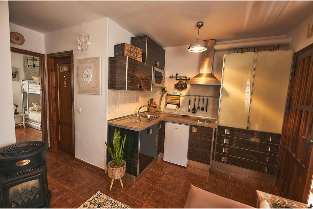 a kitchen with a sink and a stove at Buddhalounge Apartments in Ronda