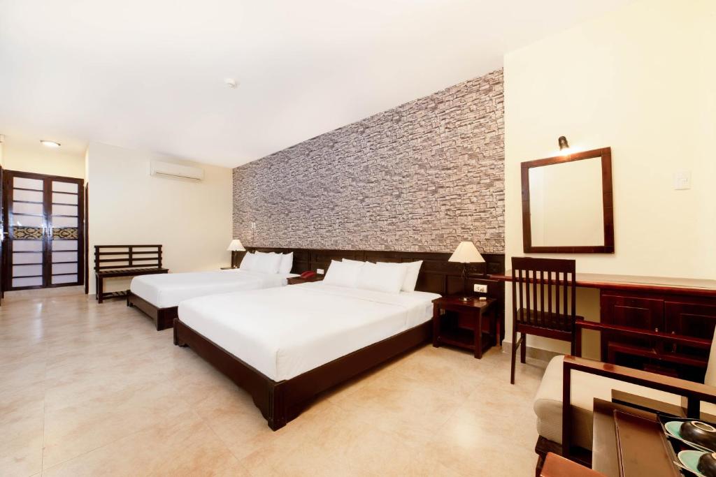 Postel nebo postele na pokoji v ubytování Gold Coast Da Nang Hotel