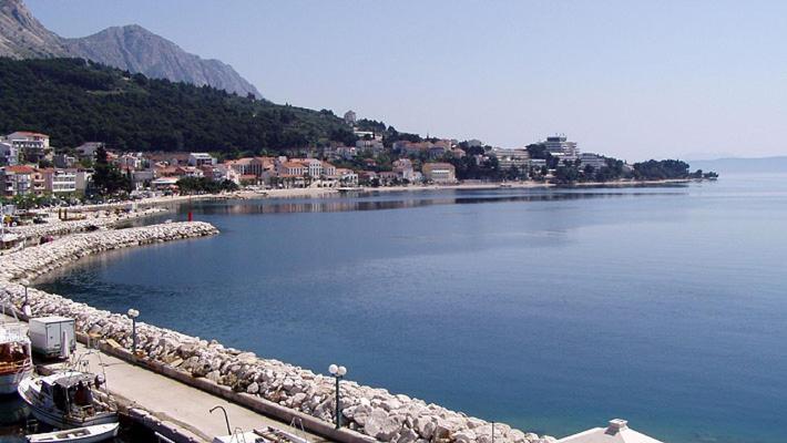 a large body of water with a town in the background at Apartments Waterfront IVAN 2 in Podgora