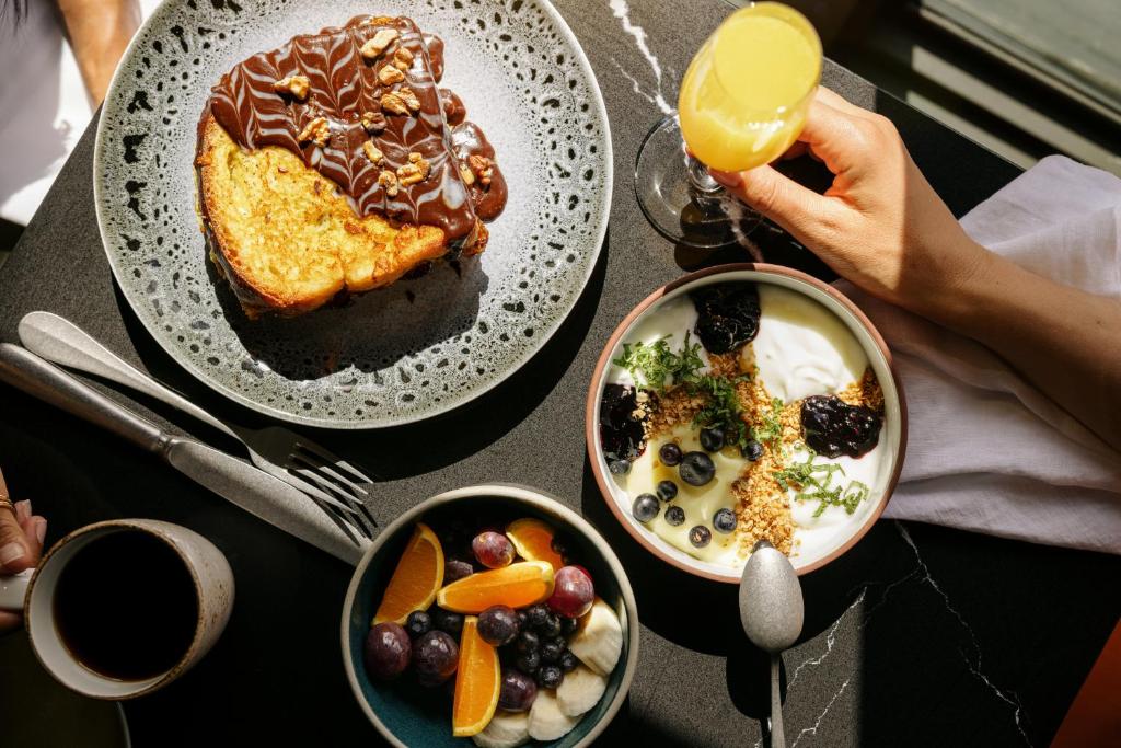 a table topped with plates of food and desserts at Mount Royal Hotel in Banff