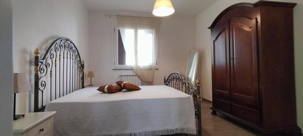 een slaapkamer met een bed met een houten bedframe bij LA CASA DI SOPRA in Martano