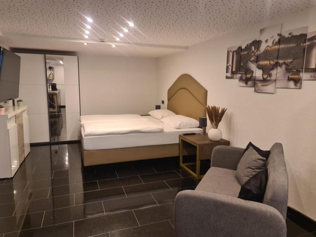 una camera con letto, divano e tavolo di Appartement am Ziegeleipark a Heilbronn