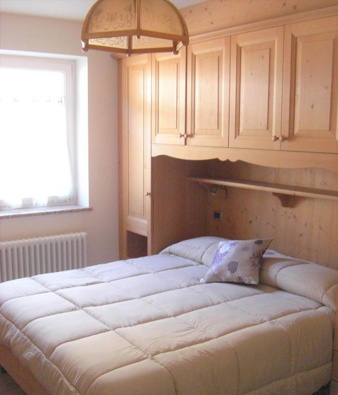 Postel nebo postele na pokoji v ubytování Paradise Apartments Paganella