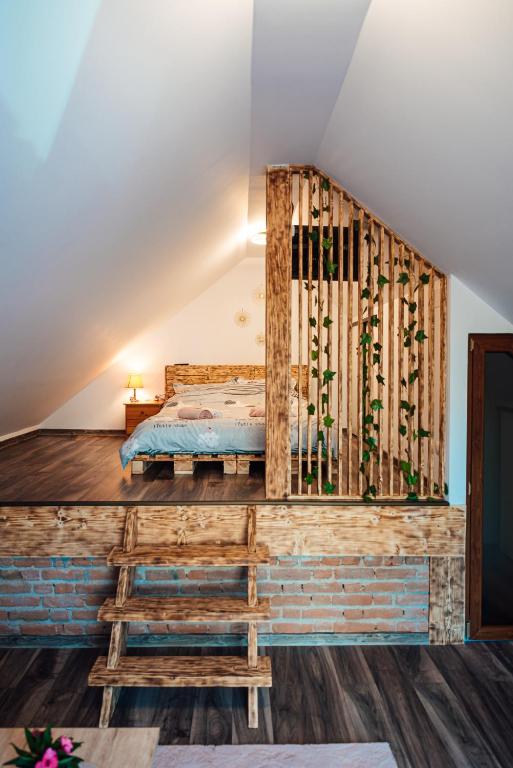 a bedroom with a bed in the attic at Casa Sara in Turda