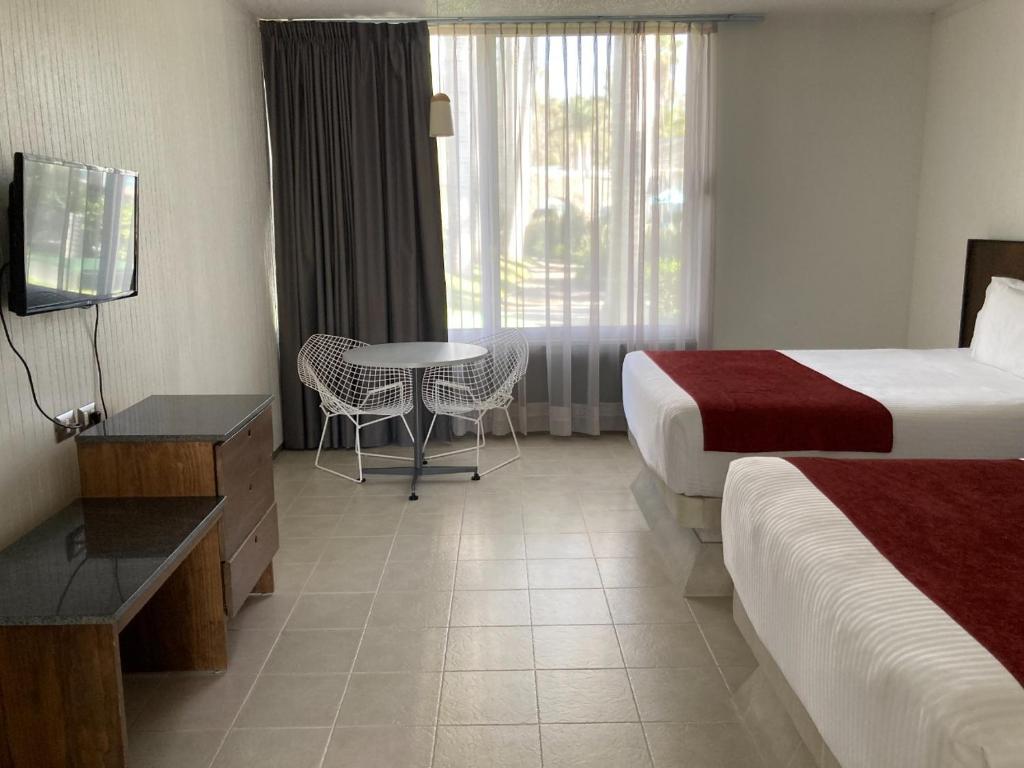 Postel nebo postele na pokoji v ubytování Hotel Y Parque Acuático La Caldera