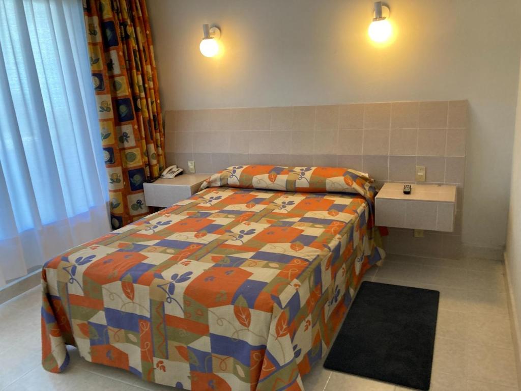 Postel nebo postele na pokoji v ubytování Hotel Y Parque Acuático La Caldera