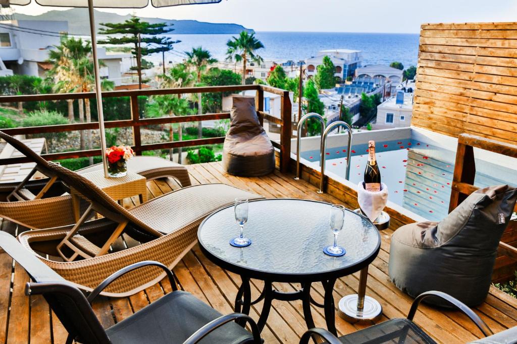 a balcony with a table and chairs and a view of the ocean at Galini Sea View Hotel in Agia Marina Nea Kydonias