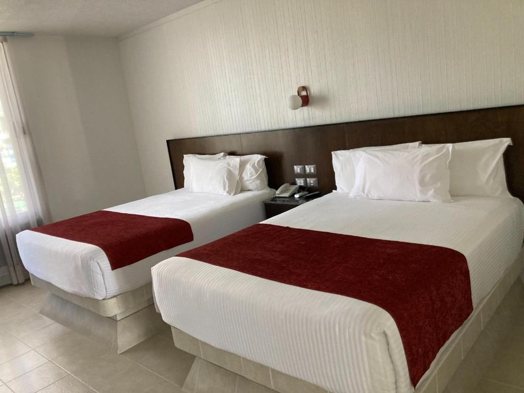 Postel nebo postele na pokoji v ubytování Hotel Y Parque Acuático La Caldera