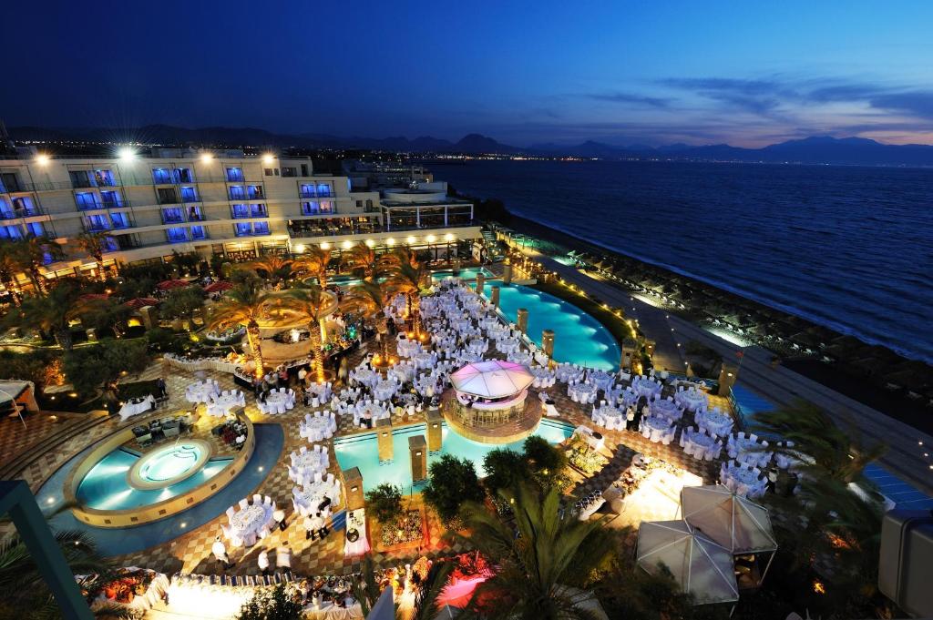 an aerial view of a hotel and the ocean at night at Club Hotel Casino Loutraki in Loutraki