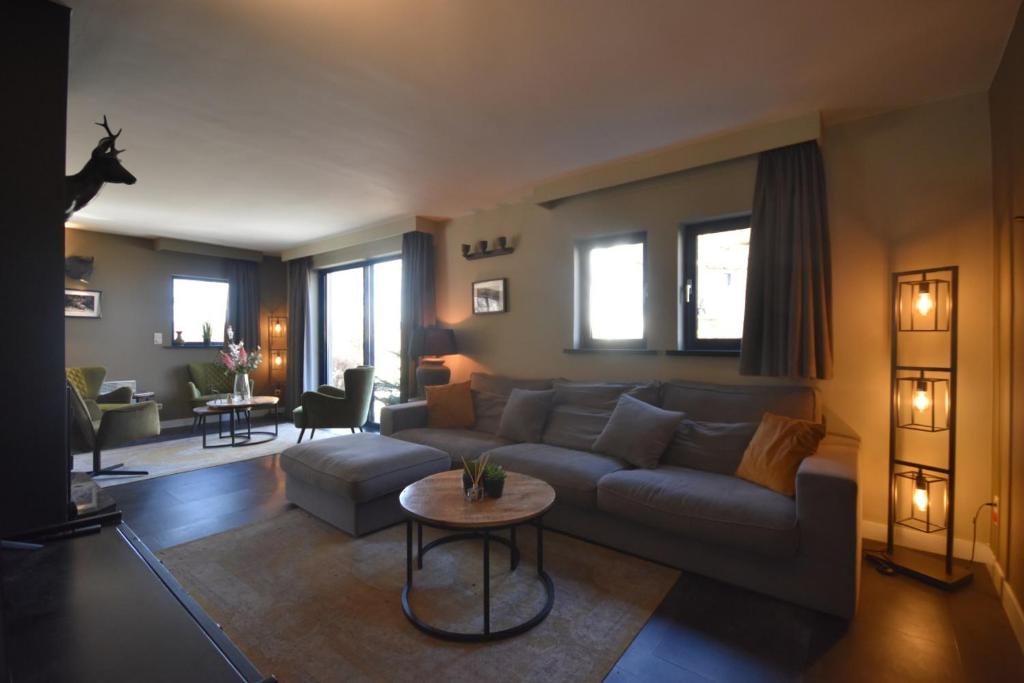 a living room with a couch and a table at DURBUY-COSY APPARTEMENT in Durbuy