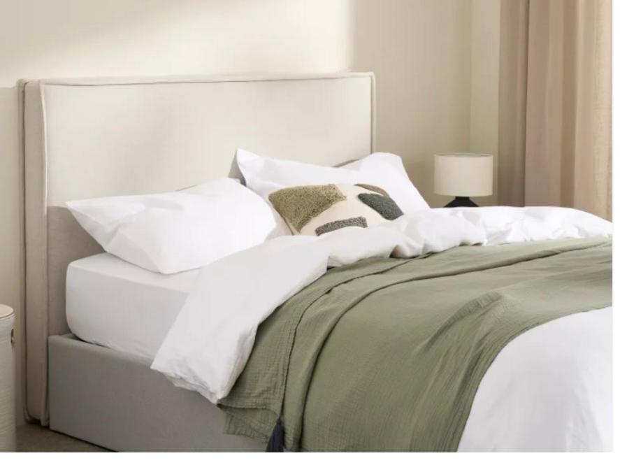a bed with white sheets and pillows on it at Lou Mut in Lectoure