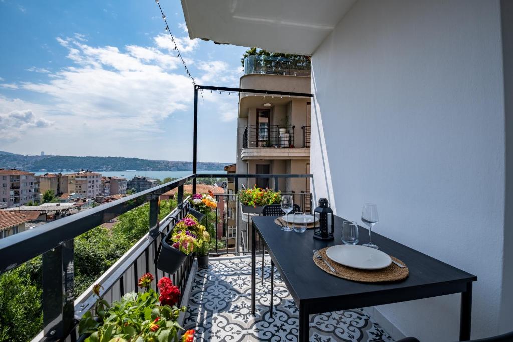 a balcony with a table and a view of the water at Spacious 2 Bedroom with Panoramic Bosphorus view in Istanbul