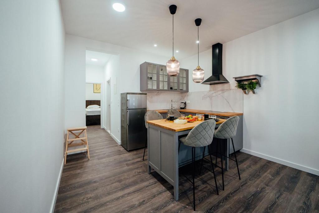 a kitchen with a counter and a island with stools at Apartman Biokovo in Imotski