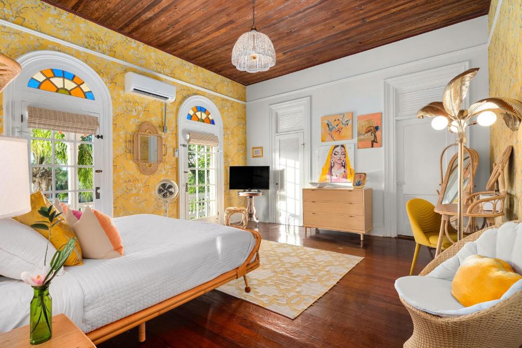 a bedroom with a bed and a living room at Marreros Guest Mansion - Adult Only in Key West